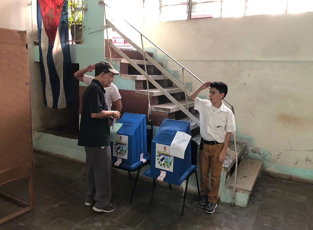 Two Cuban pioneers casting a military salute during last Parliamentarian elections (March 2018). Vedado district, Havana.